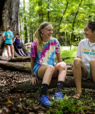 Two girls sitting under the Big Tree talking