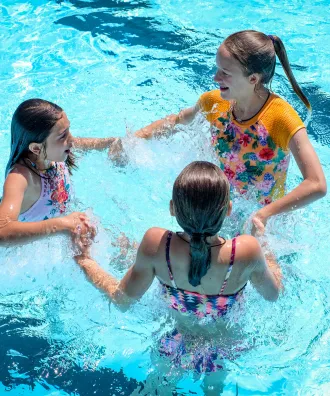 Three girls in the swimming pool.