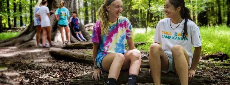 Two girls sitting under the Big Tree talking