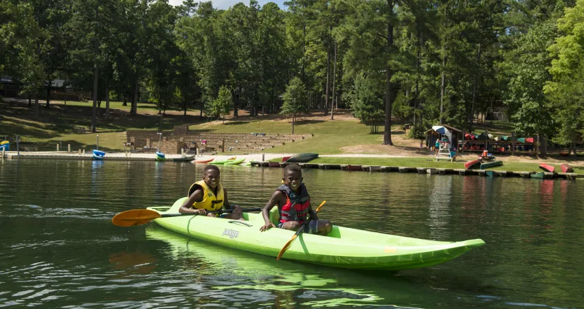 Two boys in a kayak on the lake