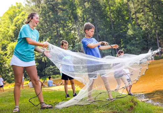 Campers and counselor with casting net 